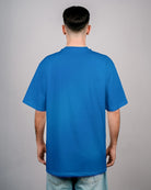 Défier oversize T-Shirt with Rooster Patch in blue