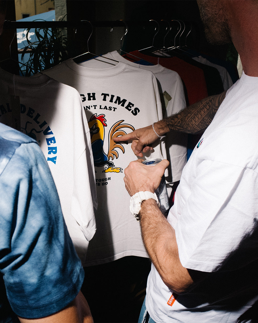 Oversized T-shirts from Défier on a clothes rack.